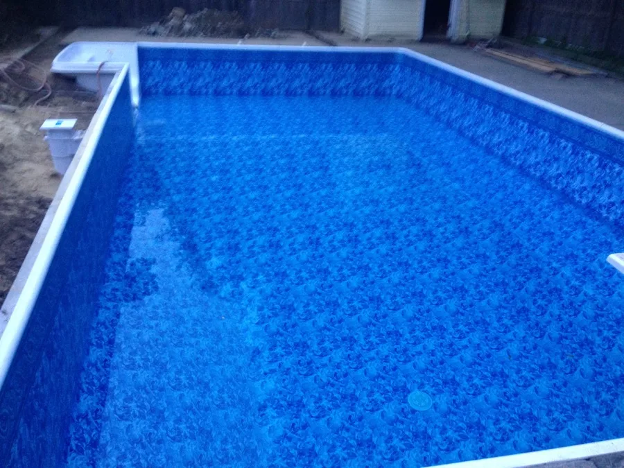 Rectangular in-ground pool with steel handrails