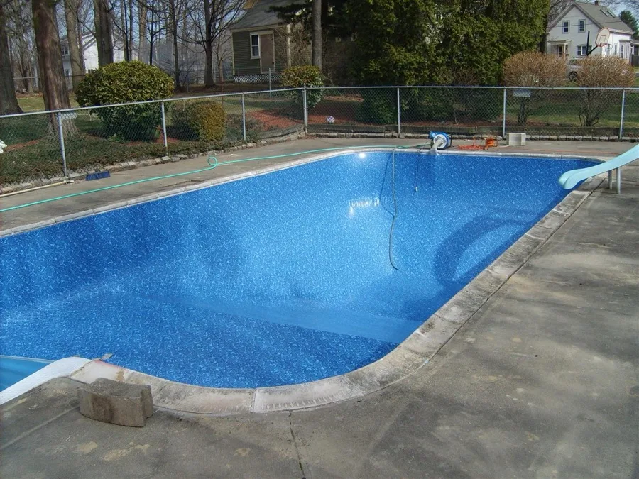 Curved in-ground pool with pool slide